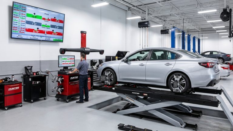 Comparison of replacing one tyre vs two tyres on same axle showing new and worn tyres in garage