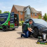 Mobile tyre fitter changing car tyre at home driveway in Wellingborough with service van